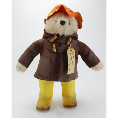 85 - Original Gabrielle Designs Paddington Bear in yellow Dunlop boots, brown coat and orange hat, with t... 