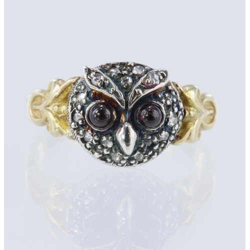 37 - Yellow gold (tests 14ct) owl ring, set with cabochon garnet eyes measuring 2.5mm each, surrounded wi... 