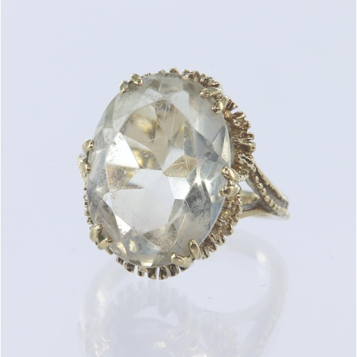 77 - 9ct yellow gold cocktail ring set with one oval mixed cut rock crystal measuring 18mm x 13mm, six do... 