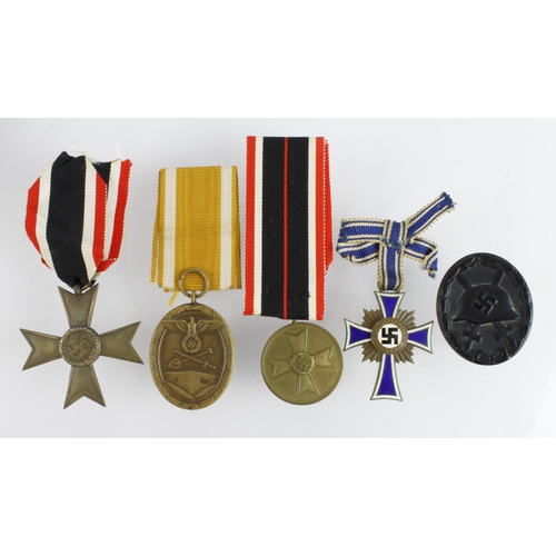 163 - German Nazi medals / badges. Mother Cross in bronze. Black Wounds badge in paper packet. Merit Medal... 