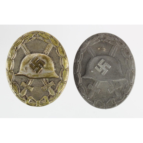 215 - German Nazi Silver Wounds Badges, solid types, maker marked '127' and '30'. (2)