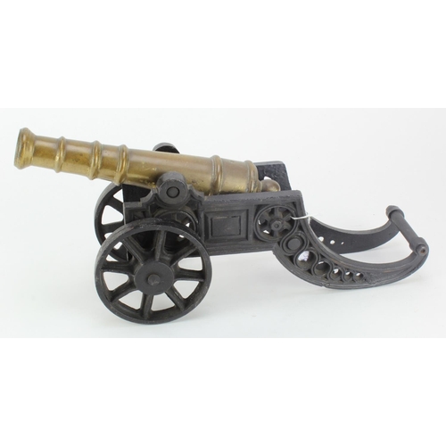 1333 - Cannon mounted on cast iron carriage with brass barrel. Total length 18