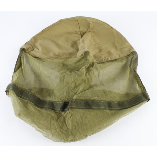 2537 - WW2 1944 dated unissued mosquito net cover used in the Far East fits over the steel helmet.