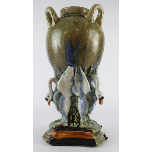 226 - Large glazed majolica three handle vase, supported by three geese, circa 19th Century, marks to base... 