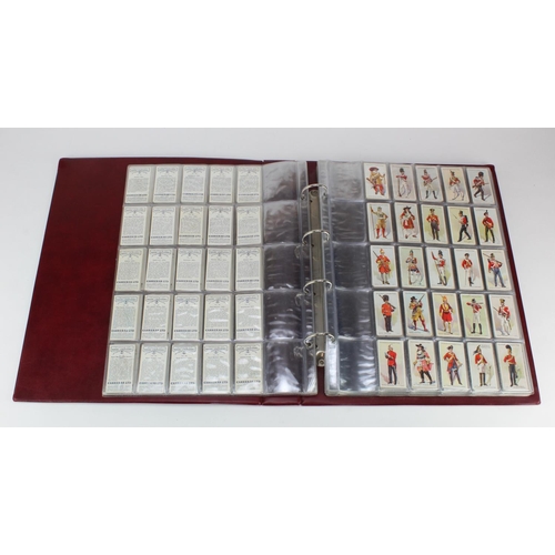 1055 - Large red binder of Military themed cigarette card sets (x16), incl Players, Wills, Ogdens, Carreras... 