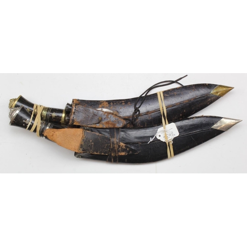 1157 - Gurkha Kukris for the tourist market in their leather scabbards, with their small sharpening & skinn... 