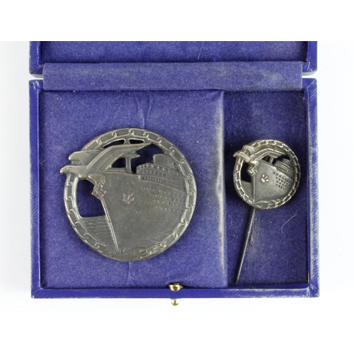 1276 - German Blockade Runners War badge unmarked with matching miniature stick pin in fitted case.