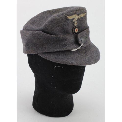 2156 - WW2 German Enlisted Mans M43 Field Cap. Late war single button type. Folds down to keep ears warm.