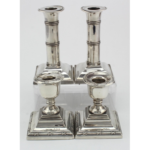 1032 - Two pairs of silver candlesticks - all have loaded bases - the small ones measure 87mm in height app... 