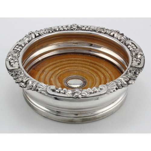 1041 - Silver plated wine coaster, has a very fancy ornate top and has age.