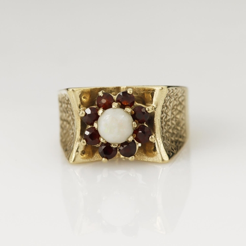 109 - Yellow gold (tests 9ct) garnet and opal cluster ring, round cabochon opal measures 5mm, surrounded b... 