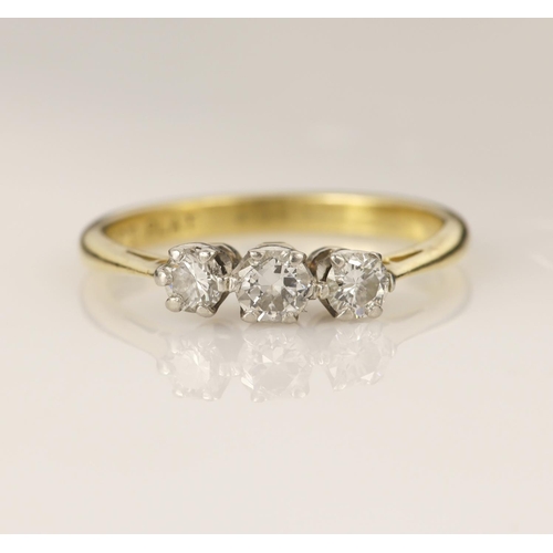 183 - Yellow gold (tests 18ct) diamond trilogy ring, set with three round brilliant cut graduating diamond... 