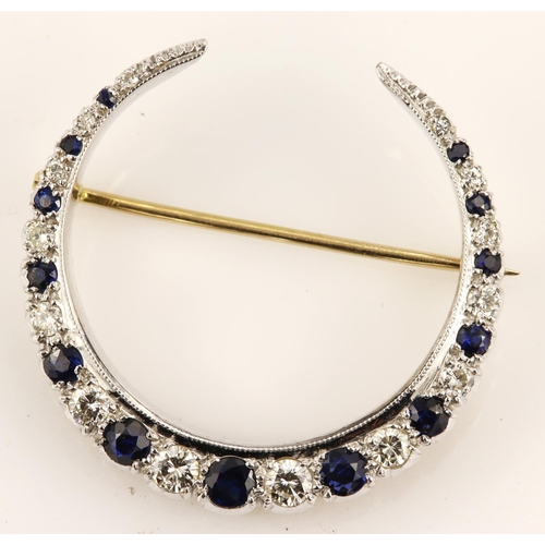 384 - 18ct yellow gold diamond and sapphire crescent brooch, set with fourteen round brilliant cut diamond... 