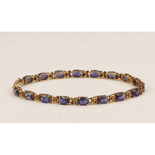 569 - 9ct yellow gold amethyst set bracelet, set with seventeen oval mixed cut amethyst's measuring approx... 