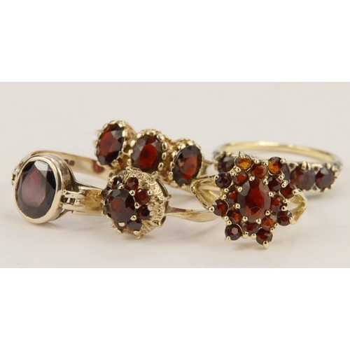 582 - Five 9ct gold/tests 9ct garnet dress rings. Total weight 16.3g.