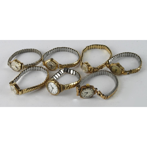 657 - Seven ladies 9ct cased wristwatches all with non-gold expandable bracelets. AF