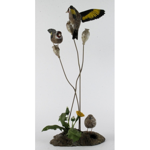 869 - Mike Wood. A carved wood & metal sculpture by Mike wood, titled to base 'Goldfinch' (1/2000), depict... 