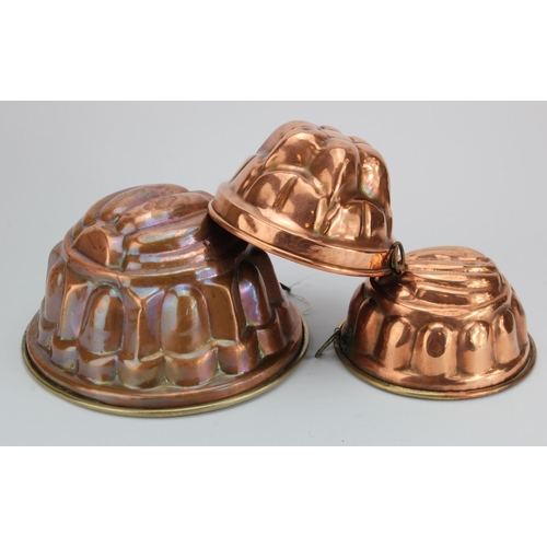 393 - Jelly Moulds. Three 19th Century copper jelly moulds, largest height 12cm, diameter 22.5cm approx.