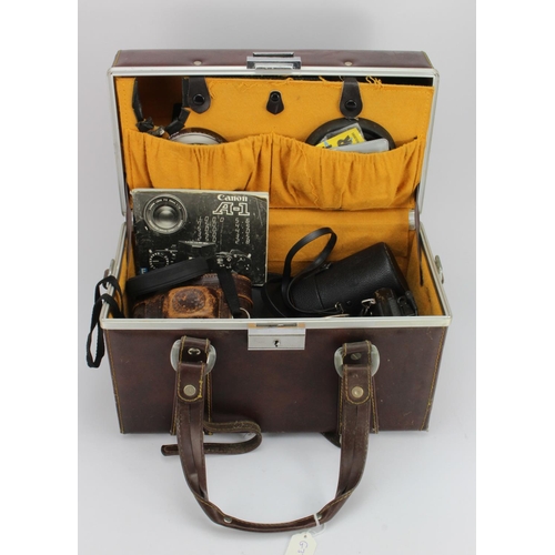 404 - Photography interest. A case containing various photography equipment, including a Canon A-1 camera ... 