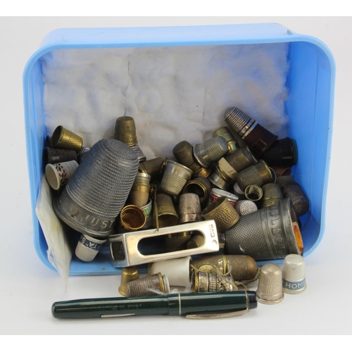 409 - Thimbles. A collection of various thimbles, together with a silver hallmarked matchbox holder (107 P... 