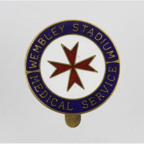 655 - St. John Ambulance related Wembley Stadium Medical Service brass & enamel hat badge.