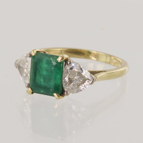 165 - Yellow gold (tests 18ct) emerald and diamond trilogy ring, emerald-cut emerald measures 7.9mm x 6.6m... 