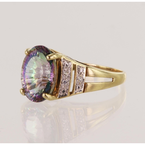 21 - 9ct yellow gold mystic topaz dress ring, oval topaz measures 14mm x 10mm, highlighted with white top... 