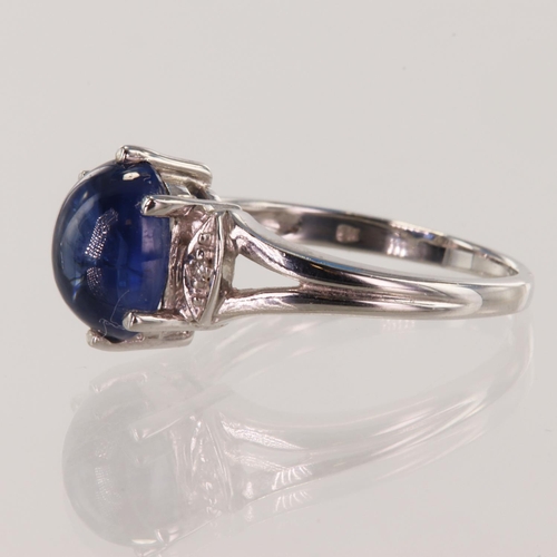 220 - 9ct white gold diamond and sapphire dress ring, oval cabochon cut sapphire approx 3.33ct, flanked wi... 