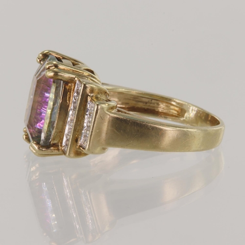 293 - 9ct yellow gold mystic topaz dress ring, oval topaz measures 14mm x 9mm, stepped shoulders set with ... 