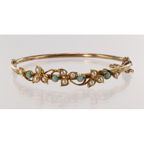 537 - Yellow gold (tests 9ct) antique turquise and half pearl bangle, scroll and foliate details, hinged w... 