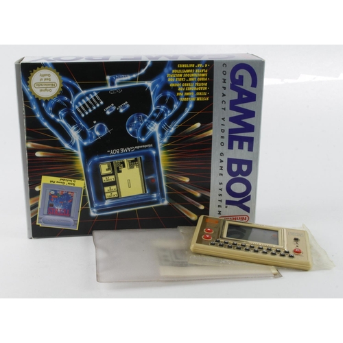 179 - Gaming interest. A boxed original red Game Boy with tetris game and instructions (missing cardboard ... 