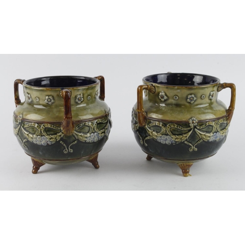 68 - Doulton Lambeth pair of Stoneware three handled cauldron pots (no. 6948), both raised on three legs,... 