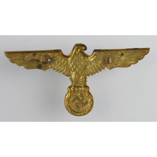 1297 - German WW2 brass eagle spanning 110 mm across, pins on the back damaged.