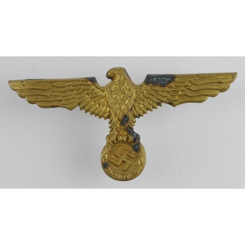 1297 - German WW2 brass eagle spanning 110 mm across, pins on the back damaged.