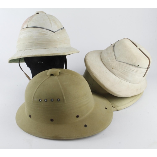 1728 - Military pith helmets four different patterns.