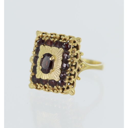 100 - Yellow gold (tests 18ct) garnet cluster ring, cluster measures 16mm x 14mm, finger size P, weight 5.... 