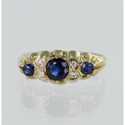 104 - Yellow gold (tests 18ct) diamond and sapphire ring, three graduating round sapphires principal measu... 