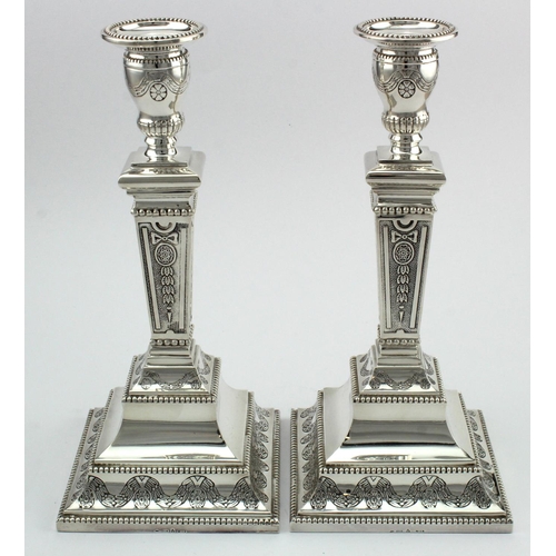 1119 - Silver pair of ornately decorated candlesticks, with silver import marks, weighted bases, height 22.... 