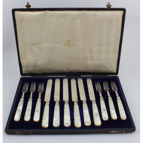 1124 - Boxed set of silver & mother of pearl fruit knifes & forks (six of each) has silver tines, blades & ... 