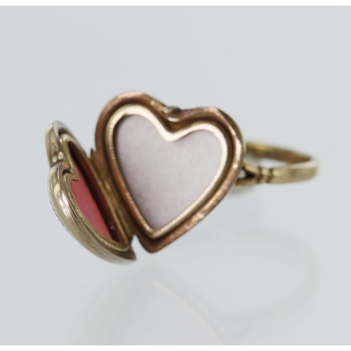 230 - Yellow gold (tests 9ct) heart shaped picture locket ring, locket measures approx. 13mm x 13mm, finge... 