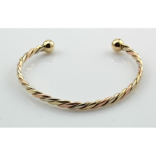 353 - 9ct tricolour rope torque bangle, twisted rope width 4mm, weight 14.8g.