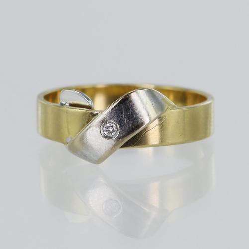 37 - Yellow gold (tests 18ct) contemporary diamond ring, white ribbon detail set with one round brilliant... 