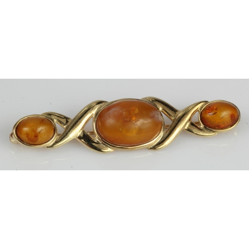 385 - 9ct yellow gold amber set brooch, set with three amber cabochons, principal measures approx. 13mm x ... 