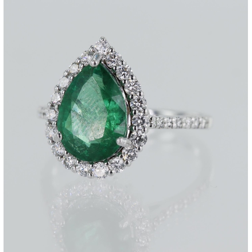 39 - White gold (tests 18ct) diamond and emerald cluster ring, pear shaped emerald approx. 2.30ct, surrou... 