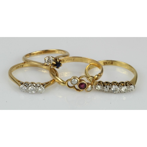 410 - Four 18ct gold/tests 18ct gold rings, to include a antique ruby and seed pearl trilogy ring, finger ... 