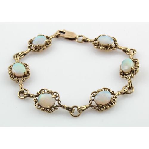 431 - 9ct yellow gold opal set bracelet, set with six oval cabochon opals measuring approx. 9mm x 7mm, len... 