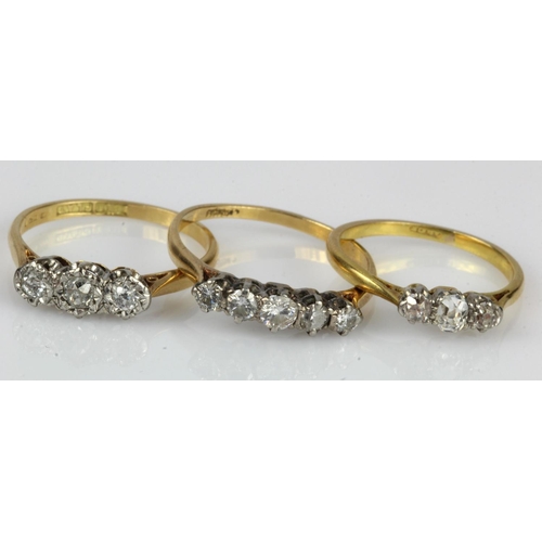 477 - Three 18ct gold/tests 18ct diamond set rings, two trilogy rings and one five stone, finger sizes L, ... 