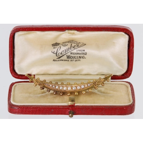 478 - 15ct yellow gold crescent shaped brooch set with eleven graduated half pearls, in fitted box. Length... 