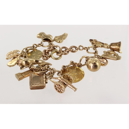 479 - 9ct / Yellow metal charm bracelet with a good variety of charms attached. Total weight 32.9g