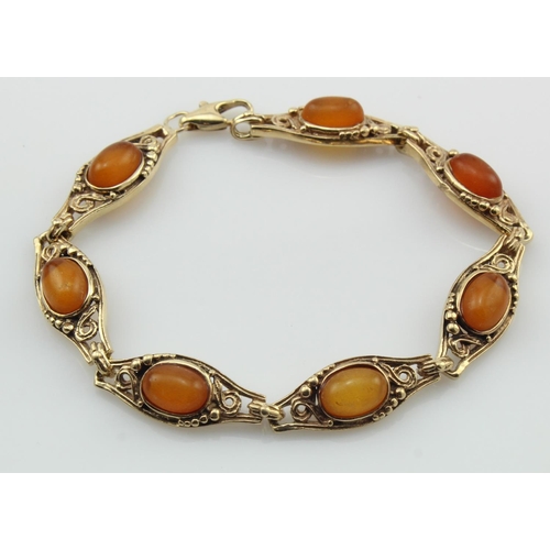 516 - 9ct yellow gold amber bracelet, seven amber cabochons approx. 9mm x 6mm each, length 7.5